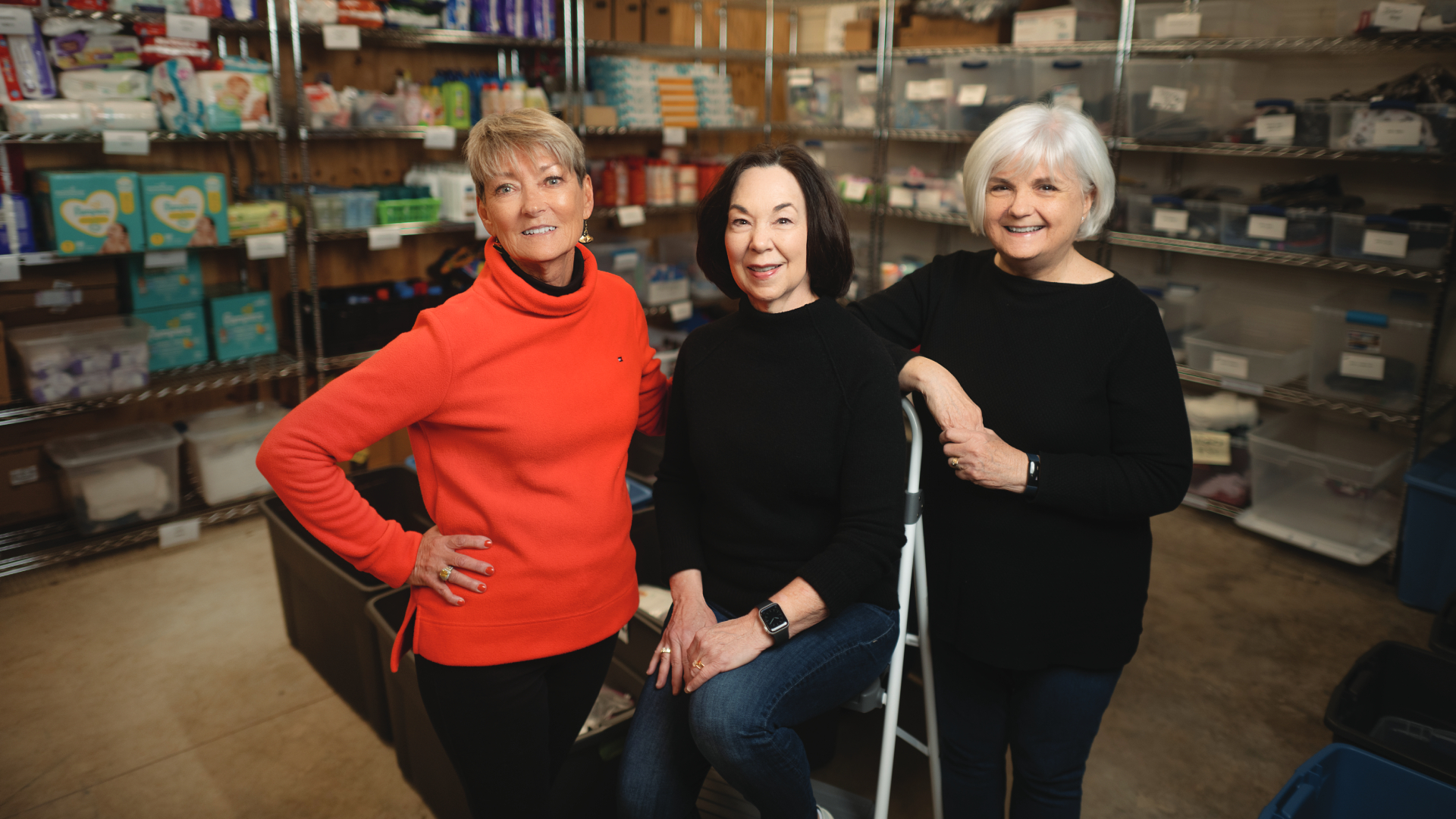 Three women, Linda, Cathy, and Sarah, stand together inside the donation closet.