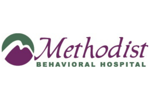 Logo for Methodist Behavioral Hospital, featuring a stylized purple mountain inside a green circle to the left of the word “Methodist” in purple script and “Behavioral Hospital” in green capital letters.